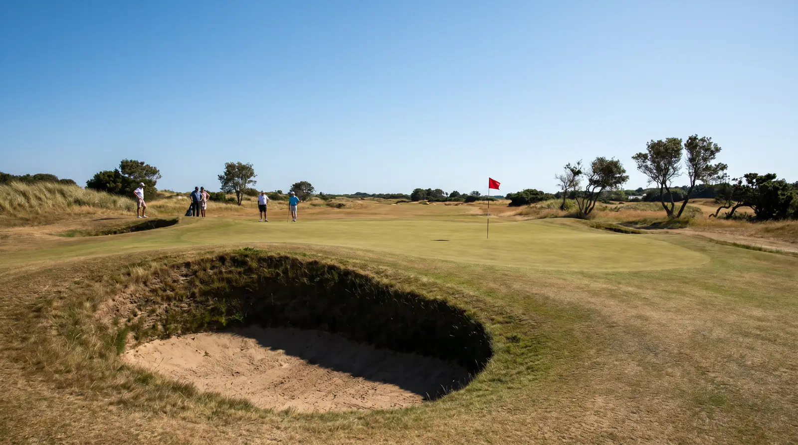 Tucked pin position behind a bunker on a US Open green setup